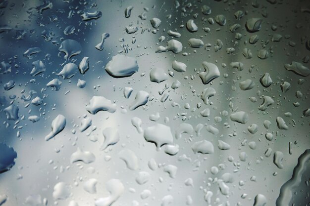 Full frame shot of raindrops on glass window