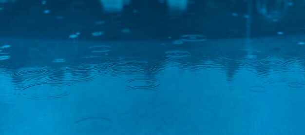 Full frame shot of raindrops on swimming pool