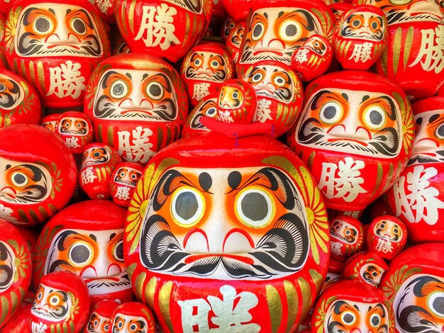 Full frame shot of red daruma dolls for sale at market