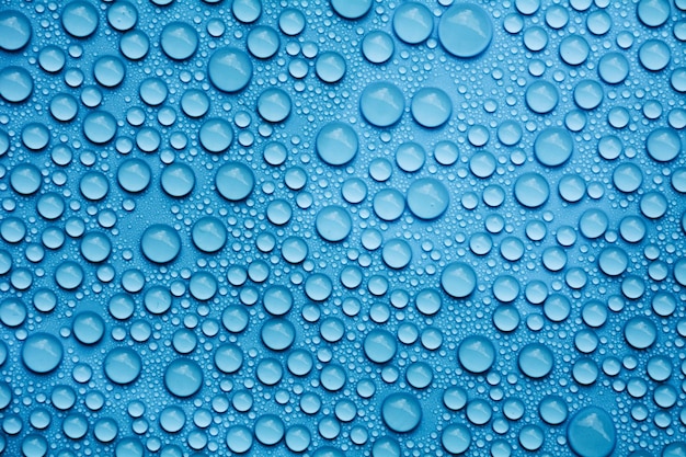 Foto fotografia completa di gocce d'acqua sulla superficie blu