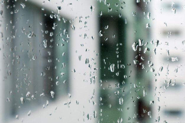 Full frame shot of wet glass window during rainy season