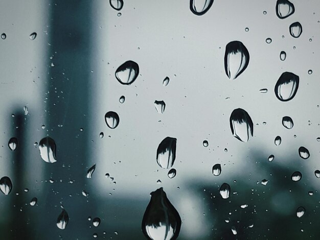 Photo full frame shot of wet glass window during rainy season