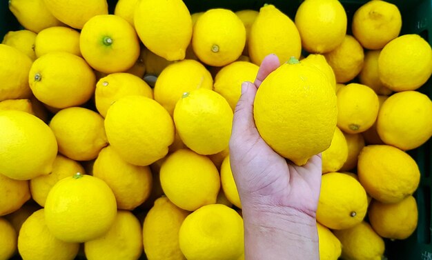 Full frame shot of yellow fruits on hand