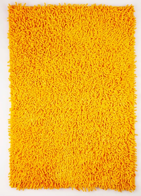 Full frame shot of yellow rug against white background