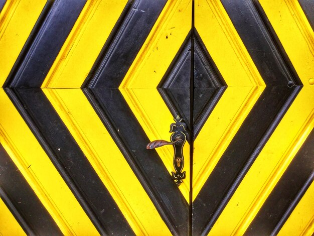 Full frame shot of yellow sign on metal