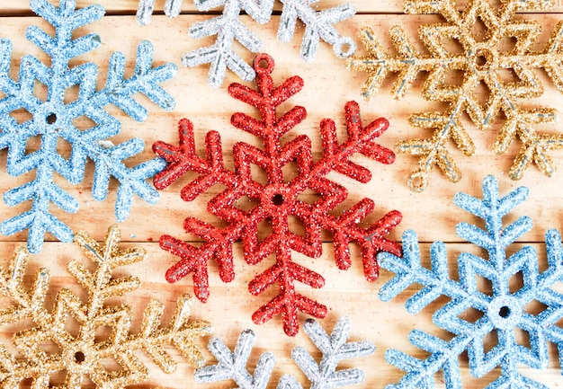 Full frame snowflakes background on the wooden