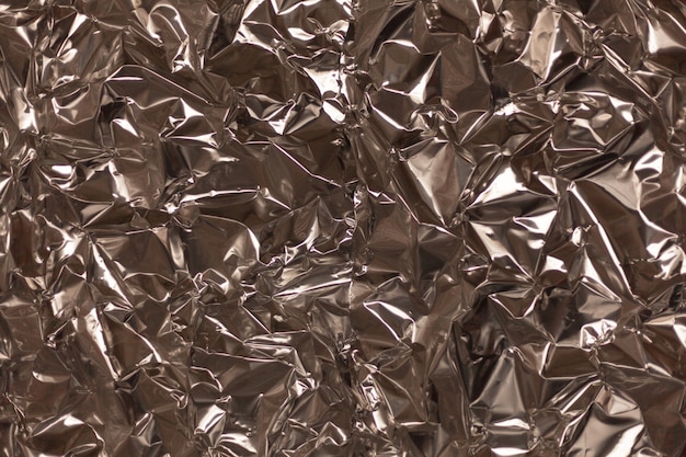 Photo full frame take of a sheet of crumpled silver aluminum foil