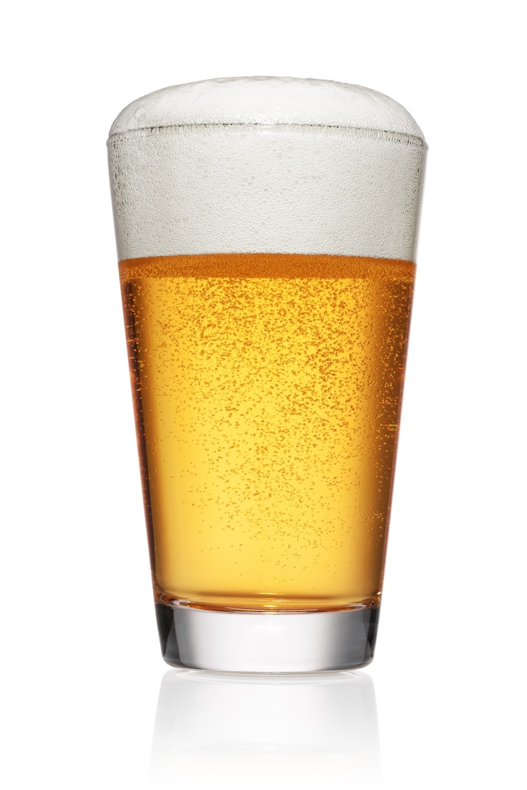 Photo full glass of light yellow beer isolated on white background.