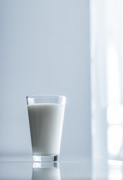 A full glass of milk on a table