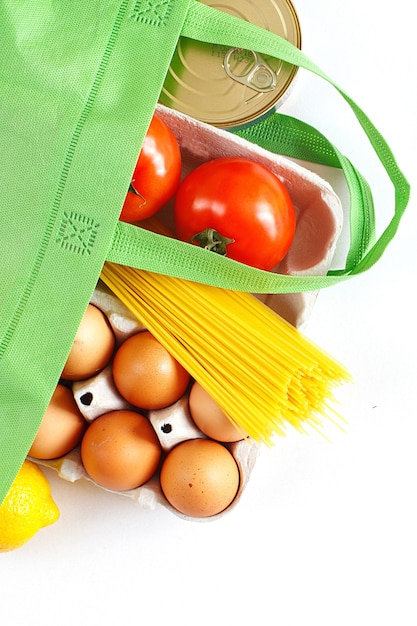 Full green bag of healthy food on a white background