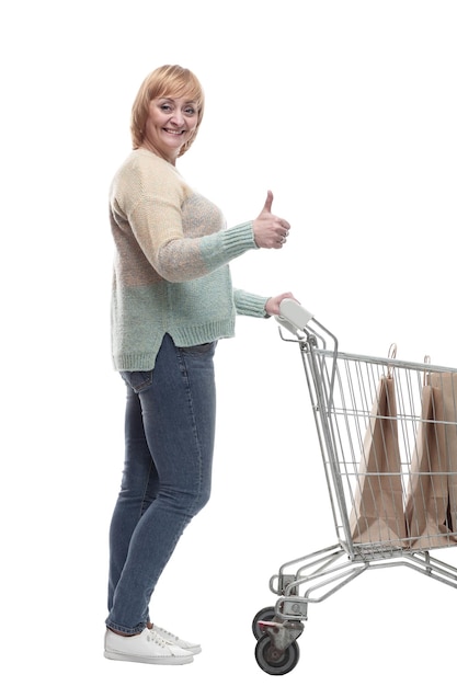 Photo in full growth attractive casual woman with shopping cart