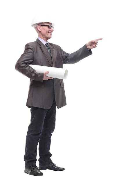 In full growth. business man in a protective helmet with drawings. isolated on a white background.