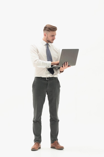 In full growth businessman using laptopisolated on white background