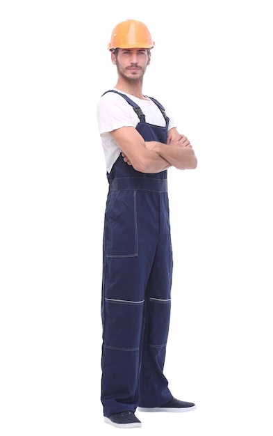 In full growth confident man wearing overalls and a crash helmet isolated on white background