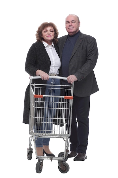 In full growth an elderly couple with a shopping cart
