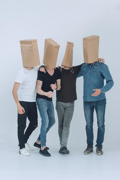 In full growth a group of men with paper bags on their headsphoto with copy space