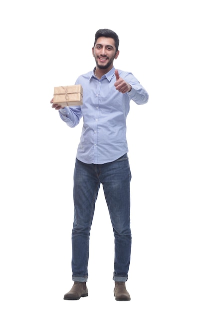 in full growth happy young man with a gift in craftpaper isolated on a white background