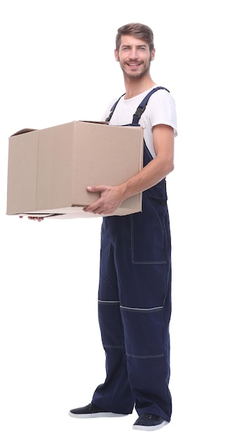 In full growth a man in a jumpsuit holding a large boxisolated on white background