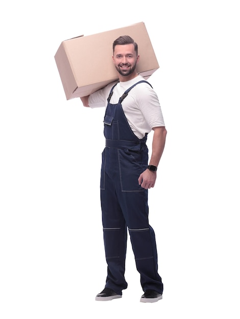 In full growth a man in overalls with a box on his shoulder