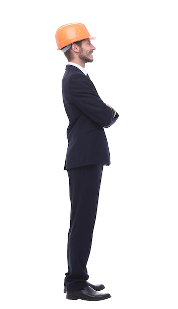 In full growth a serious businessman in a protective helmet isolated on white background