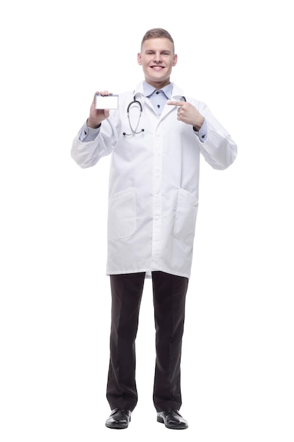 In full growth. smiling doctor showing his visiting card. isolated on a white background.