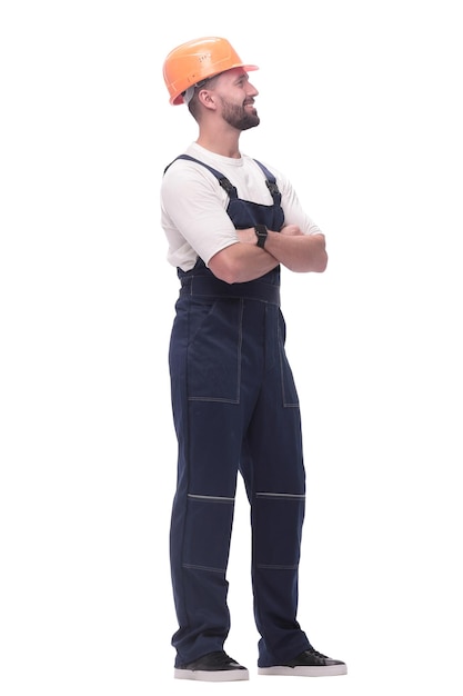 In full growth smiling man in overalls and a safety helmet