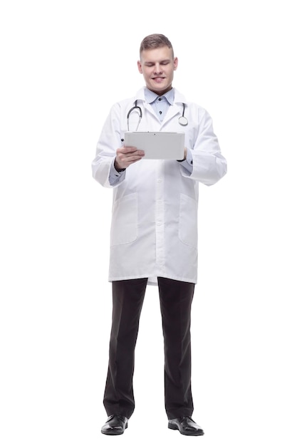 In full growth. young doctor with a digital tablet. isolated on a white background.