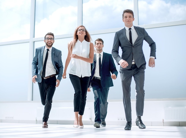 In full growthbusiness team passing through the hall of the office