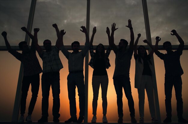 In full growthfriendly business team standing near the office window the concept of teamwork