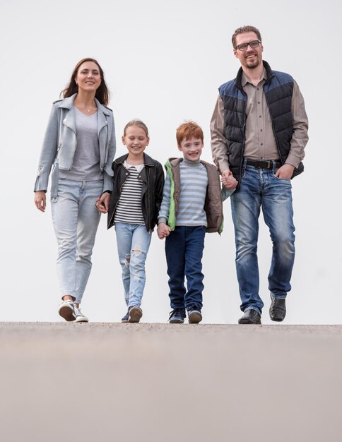 In full growthyoung family with their children walking togethe