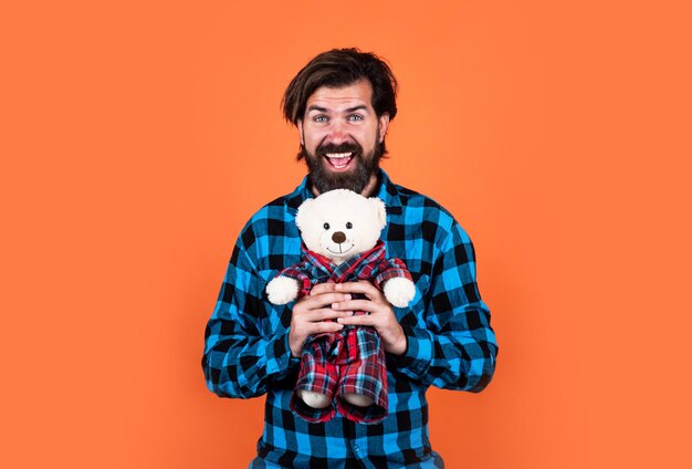 Full of happiness gift with love handsome hipster having playful mood happy fathers day mature man with bear toy bearded man hold teddy bear brutal guy with valentines day present
