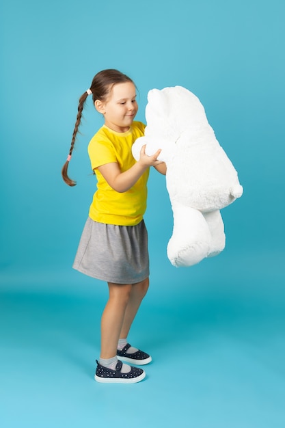 At full height the girl dancing with a white Teddy bear