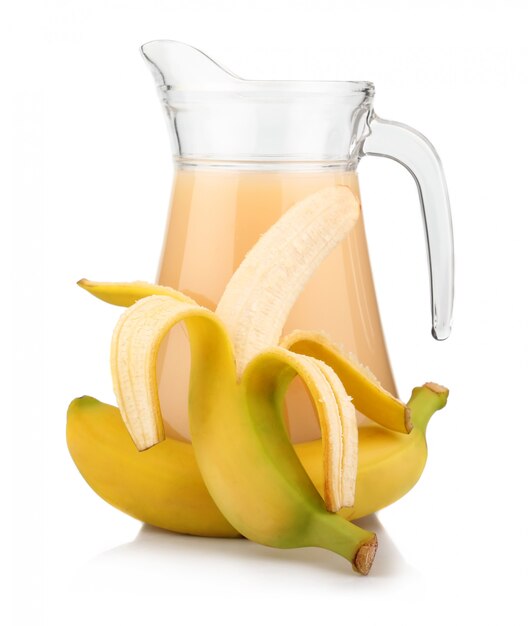 Full jug of banana juice and fruits isolated