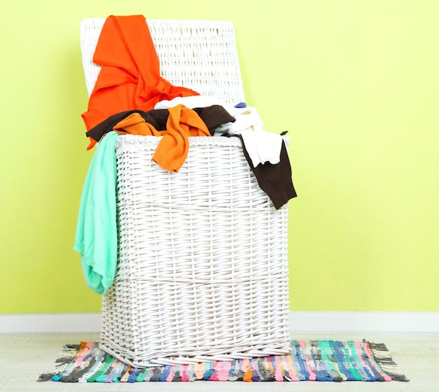 Full laundry basket on wooden floor