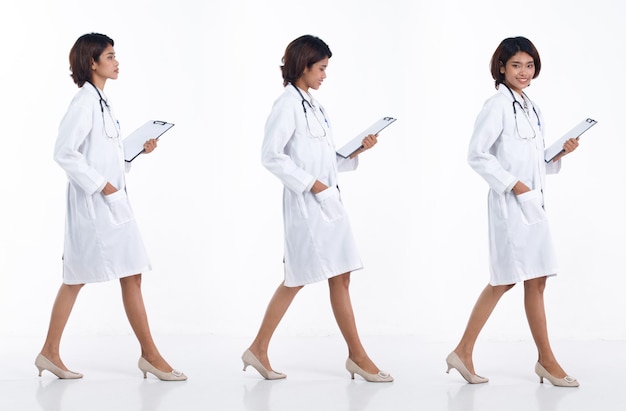 Full length 20s young Asian Doctor Woman wear stethoscope uniform coat walking forward right