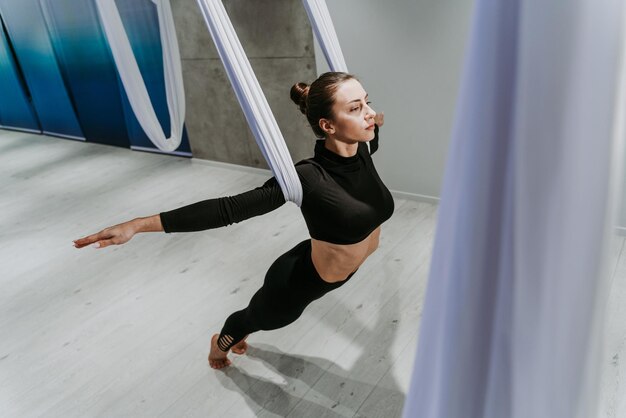 Full length of ballet dancer practicing dance at gym