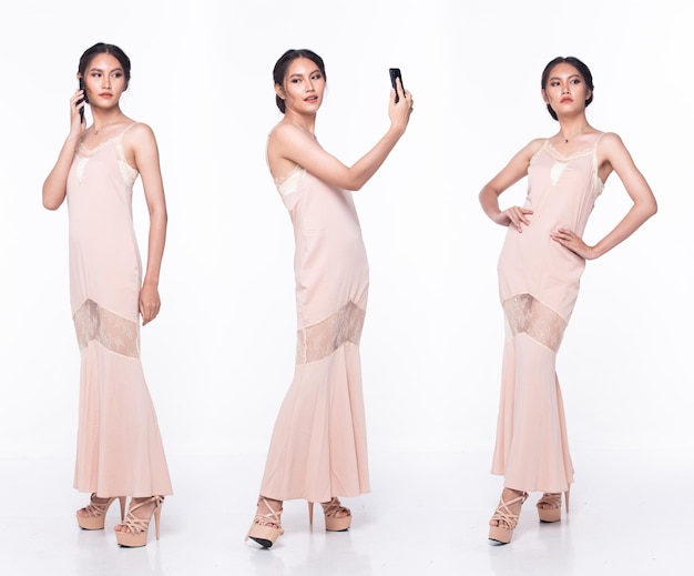 Full length body of Asian beautiful woman wear Pink evening sequin gown working internet phone