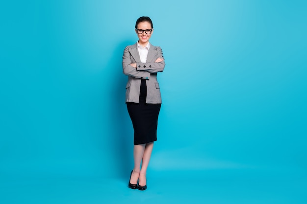 Full length body size view of attractive cheerful businesslady leader folded arms isolated over vibrant blue color background