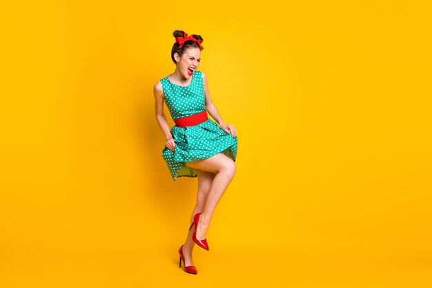 Full length body size view of attractive cheerful girl dancing having fun enjoying amusement isolated on bright yellow color background