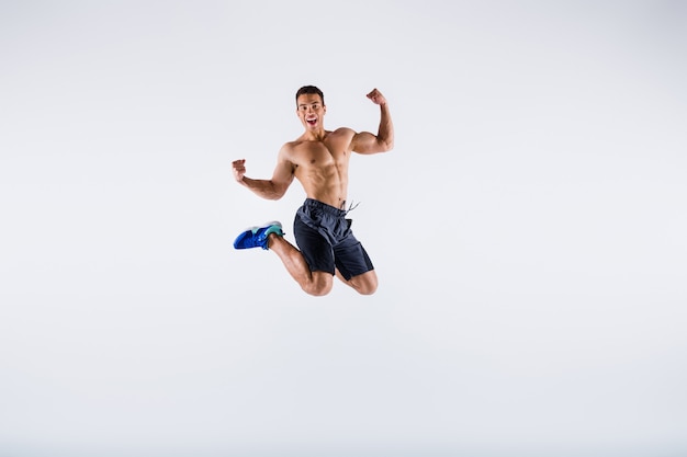 Full length body size view of guy jumping rejoicing winning isolated white color background