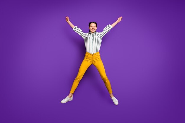 Full length body size view of her she nice attractive cheerful cheery funky girl jumping up having fun like star figure isolated over bright vivid shine vibrant violet purple lilac color background