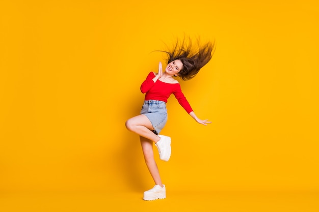 Full length body size view of her she nice attractive lovely cheerful cheery thin fit girlish slender girl dancing having fun summertime isolated bright vivid shine vibrant yellow color background