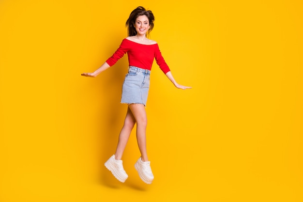 Full length body size view of her she nice attractive pretty lovely cheerful cheery thin skinny girl jumping having fun strolling enjoy isolated bright vivid shine vibrant yellow color background