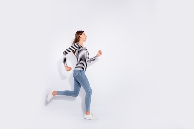 Full length body size view of her she nice-looking attractive charming cheerful cheery straight-haired girl running marathon free time weekend isolated over white light wall