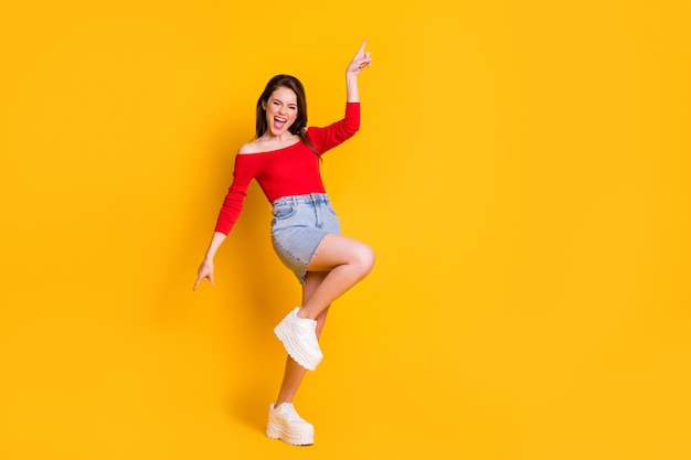 Full length body size view of her she nice-looking attractive cheerful thin girl dancing having fun chill out relax nightclub isolated bright vivid shine vibrant yellow color background