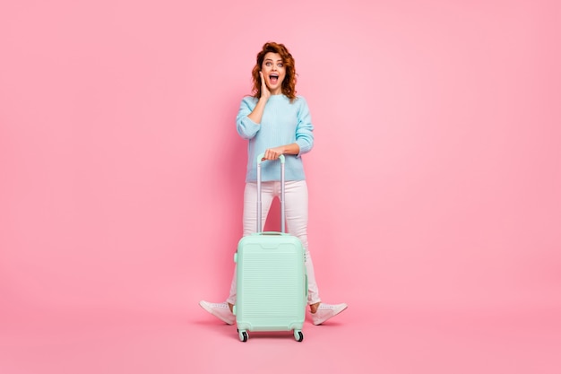 Full length body size view of her she nice-looking attractive lovely glad cheerful cheery wavy-haired girl holding in hand luggage having fun departure isolated over pink pastel color background