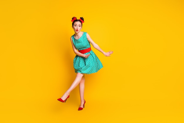 Photo full length body size view of lovely funky girl dancing having fun sending air kiss isolated on bright yellow color background