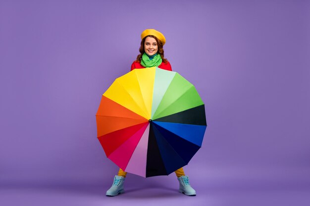 Full length body size view of nice attractive lovely pretty cheerful cheery wavy-haired girl holding spinning umbrella having fun isolated on violet lilac purple pastel color background