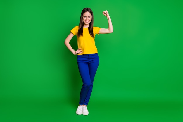 full length body size view portrait of cheerful fit girl showing biceps