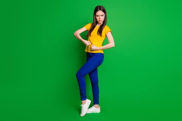 full length body size view portrait of slim fit girl showing biceps muscles